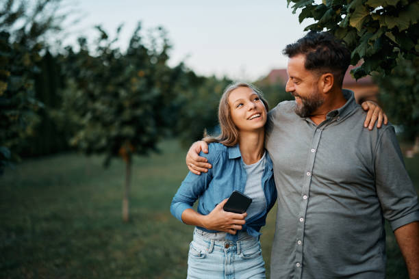 happy-man-talking-to-his-teenage-daughter-in-the-backyard